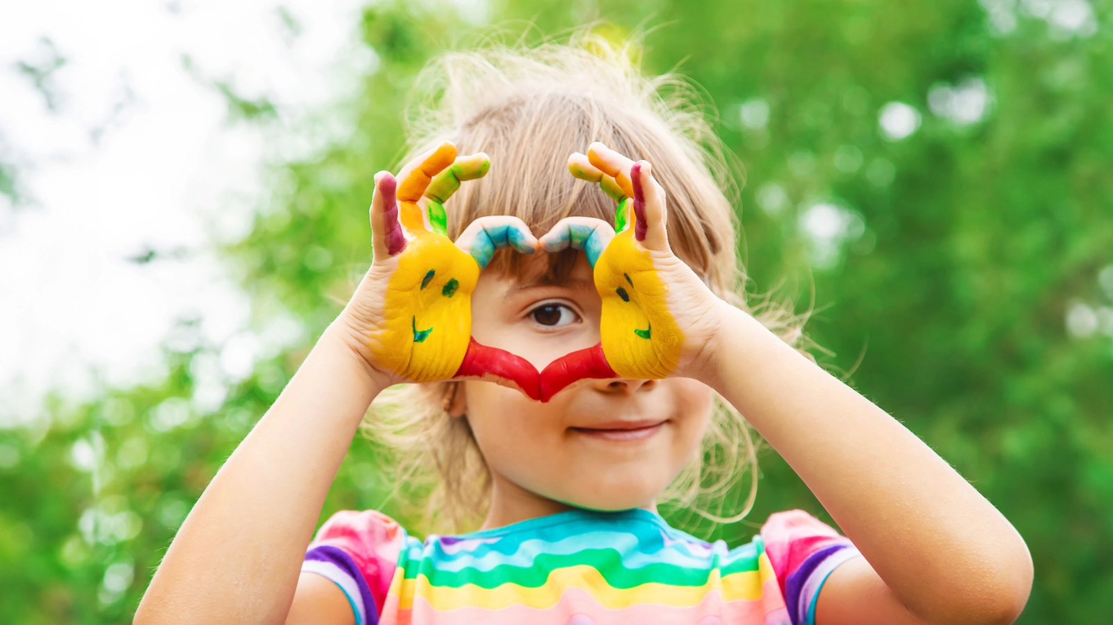 Young girl making heart sign